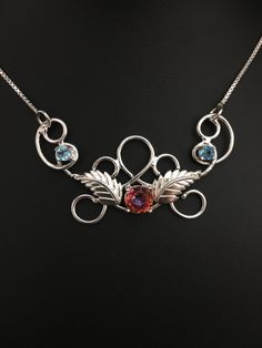 I've created a magical and unique statement necklace meant for a wedding, or faery wear for any occasion. This piece is fabricated in sterling silver and features two 4mm blue Topaz gems and a center, brilliant Blush Topaz 8mm round faceted. It's a magical necklace and one of my favorites to fabricate ! These are genuine gemstones. They are not glass simulated. The pendant is 2 1/2 inches across and comes with a sterling silver 16 inch box chain attached to either end. Let me know if you want th Whimsical Sterling Silver Wedding Jewelry, Silver Ethereal Jewelry With Birthstone, Ethereal Sterling Silver Pendant Necklace, Unique Hand Forged Wedding Necklaces, Unique Hand Forged Wedding Necklace, Unique Hand Forged Necklace For Wedding, Handmade Sterling Silver Necklace For Wedding, Fantasy Sterling Silver Jewelry For Anniversary, Ethereal Sterling Silver Jewelry