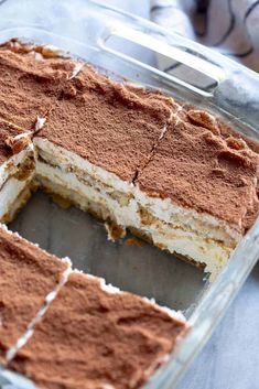 a cake that has been cut into pieces and is in a glass dish on a table