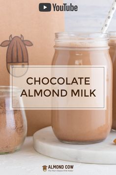 chocolate almond milk is in a glass jar next to two jars filled with almonds