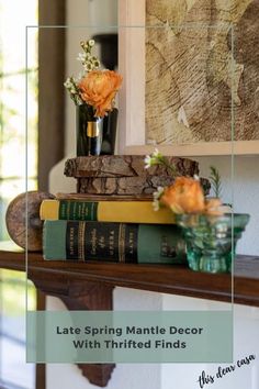 books are stacked on top of each other in front of a painting and vase with flowers