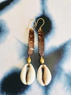 Blessings from divine messengers. These are made from coconut, brass and vintage cowrie shells from Burkina Faso. The are on gold fill hooks. Both the coconut and the cowrie shell are used in divination to communicate messages from Spirit. May these assist you in receiving what is for you.  Cowrie shells have been used around the world for adornment, currency and divination. They symbolize creation, abundance, protection, ancestors. They are considered the mouth of the gods, tools for communicat Gold Spiritual Jewelry For Vacation, Handmade Bronze Jewelry For Beach, Handmade Copper Jewelry For The Beach, Handmade Bronze Jewelry For The Beach, Handmade Copper Jewelry For Beach, Artisan Gold Jewelry For The Beach, Artisan Gold Jewelry For Beach, Artisan Gold Beach Jewelry, Bohemian Brown Cowrie Shell Jewelry