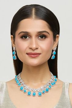 Silver plated floret design zircon encrusted necklace with turquoise blue stones embellishments. Comes with a pair of floret dangler earrings. - Aza Fashions Dangler Earrings, Blue Stones, Fashion App, Jewellery Set, Blue Stone, Aza Fashion, Turquoise Blue, Jewelry Set, Silver Plate