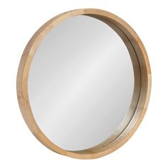 a round mirror sitting on top of a white wall