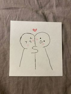 a piece of paper with a drawing of two people holding each other's hands