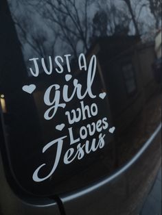 a sticker that says just a girl who loves jesus on the side of a car