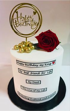 a birthday cake with a red rose on top