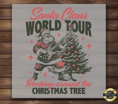 santa claus world tour rocking around the christmas tree sign on a wooden wall with wood planks