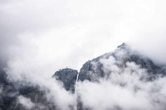 the mountains are covered in clouds and fog