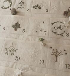 the numbers and symbols are embroidered onto linens to make christmas decorations for someone's house