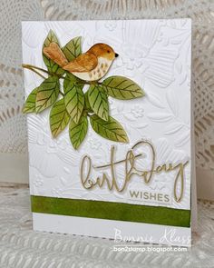 a close up of a card with a bird on a tree branch and the words cut - paper wishes