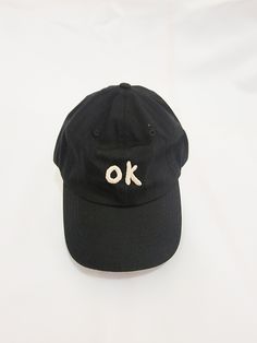 OK CAP Embroidered OK logo on the front.Cap is unstructured black daddy cap style.Back strap is adjustable. Word Cap, Ok Logo, Bunny Cap, Neat Clothes, Rain Cap, Fun Clothing, Cute Caps, Polo Women, Cap Style