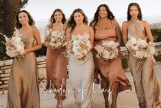 a group of women standing next to each other holding bouquets