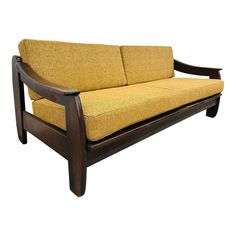 a wooden couch with yellow upholstered fabric on the back and armrests