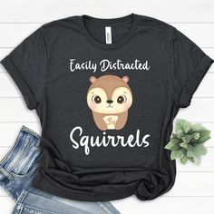 Easily Distracted By Squirrels T-Shirt | Funny Squirrel Lovers Shirt | Cute Squirrel Tee Gift | Animal Lover Shirt | Adorable Pest Shirt ----------------- AJComfortPrints are made with premium quality materials to fit your needs. Everything is printed in the USA. - Please inquire about Kid's Tees. - Feel free to message me if you have any questions. ----------------- Product Details: Unisex Tees * 100% combed and ring-spun cotton (Heather colors contain polyester) * Ash color is 99% combed and r Easily Distracted, Ash Color, T Shirt Funny, Kid Tees, Cute Shirts