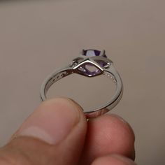 This is a gorgeous handmade creation. Its beauty is its simplicity & Elegance. The 5*7 mm oval shape faceted natural amethyst is crafted in solid sterling silver and with rhodium plated. All item is sent in a beautiful gift box If you have any idea of design your ring,pls contact me directly. You can realize more lovely stuff clicking the link https://www.etsy.com/shop/knightjewelry?refshopsection_shophome_leftnav Please leave the correct address and you phone number for delivering successfu Classic Oval Amethyst Crystal Ring, Oval Faceted White Gold Rings, Oval Faceted Crystal Promise Ring, Oval Faceted Amethyst Ring For Gift, Oval Faceted Birthstone Ring For Anniversary, Oval Amethyst Promise Ring In White Gold, White Gold Amethyst Promise Ring With Oval Shape, White Gold Oval Amethyst Promise Ring, Oval White Gold Amethyst Promise Ring