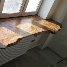 a wooden counter top sitting next to a window