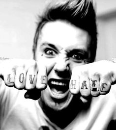 a man with his hands in the shape of letters that spell out love and hate