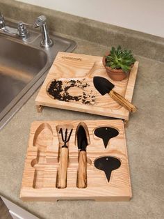 wooden utensils and spoons are sitting on a tray next to a sink