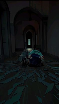 a person laying on the floor in a dark hallway with their arms around another person's head