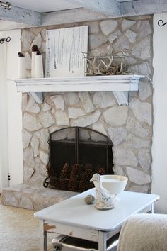 a living room filled with furniture and a fire place in front of a stone fireplace