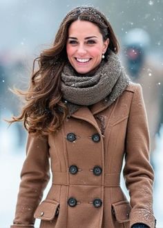 the duke and duchess of cambridge smile as they walk through the snow in their winter coats