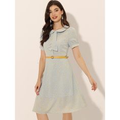 This belted dress features a floral print, a Peter Pan collar, slightly puff sleeves, and a tie-neck. This elegant dress can be worn for weekend occasions or during the working week. Short sleeves accentuate the graceful silhouette of the above-the-knee dress patterned with floral prints. This elegant floral a-line dress is cut with a Peter Pan collar, a bow-tie neck, and a bright belt. Be ready for the fun of wearing it. Retro Spring Dresses For Office, Retro Spring Office Dress, Spring Workwear Dresses With Peter Pan Collar, Cotton Fitted Dress With Peter Pan Collar, Vintage Fashion Fitted Dress With Peter Pan Collar, Spring Dress With Peter Pan Collar For Dress-up, Peter Pan Collar Dress With Ruffles For Dress-up, Pleated Dress Short, Belted Floral Dress