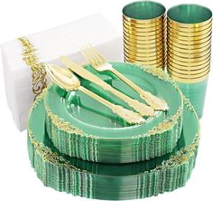 a green plate with gold rimmed plates and napkins on it, next to stacks of gold foil cups