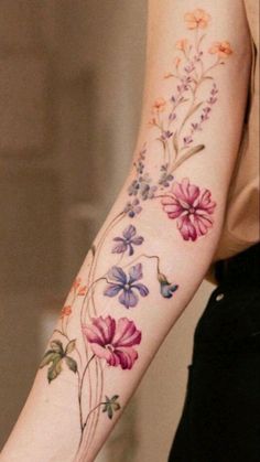 a woman's arm with flowers on it