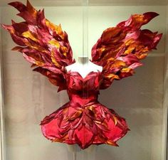 a dress made out of red and yellow leaves