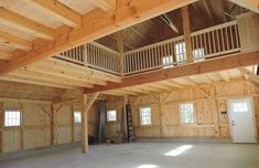 an empty room with wood paneling and wooden balconies on the second floor