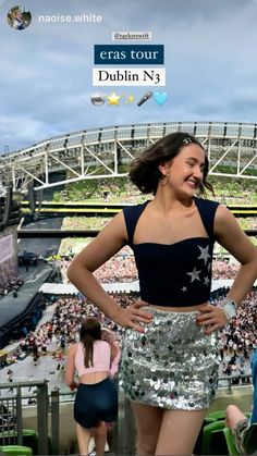 a woman standing in front of a stadium with her hands on her hips