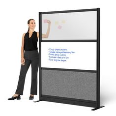 a woman standing next to a white board