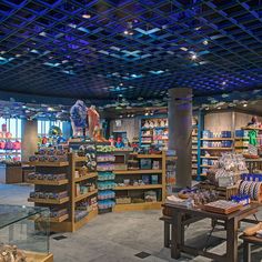 the inside of a store with many items on shelves and tables in front of them