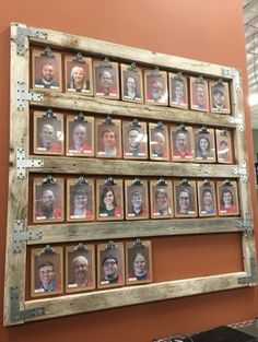 an old wooden frame with many pictures hanging on it's side in front of a wall