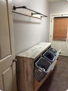 an entryway with three bins on it