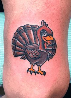 a turkey tattoo on the side of a man's leg