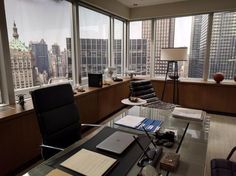 an office with large windows overlooking the city