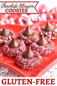 chocolate covered donuts with sprinkles are on a red plate next to hearts