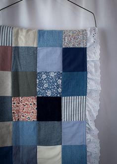 a patchwork quilt hanging on a wall