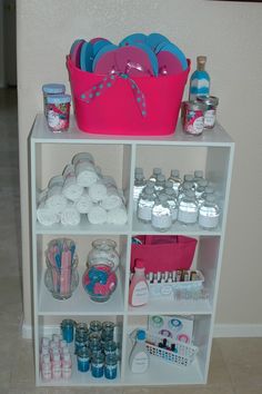 a shelf filled with lots of toiletries next to a pink basket on top of it