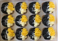 cupcakes with yellow and black frosting in a box