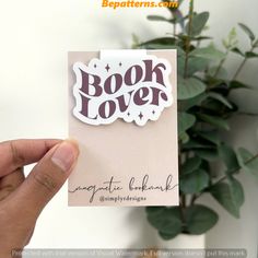 someone holding up a book lover card with the word'book lover'on it