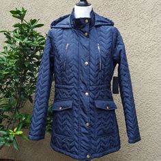 Lighter Weight Quilted Coat With Attached Hood. Navy Blue Water Resistant Polyester Shell With Antique Gold Hardware. Front Zipper And And Snap Closure. Fully Lined. Two Front Patch Pockets And Two Zippered Chest Pockets. Adjustable Hidden Elastic Draw String At Waist. Sz M Waist -18.5"; Bust -19.5" Pit To Pit; 25" Sleeve Length And Just Over 29" Overall Length. Nwt Quilted Long Sleeve Jacket With Drawstring Hood For Fall, Quilted Jacket With Drawstring Hood For Fall, Casual Quilted Jacket With Double-lined Hood, Navy Long Sleeve Outerwear With Double-lined Hood, Blue Quilted Jacket For Cold Weather In Fall, Fall Quilted Jacket With Double-lined Hood, Blue Quilted Jacket For Fall, Navy Hooded Outerwear For Cold Weather, Navy Quilted Outerwear For Fall