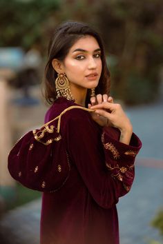 PRODUCT DETAIL: This wine velvet set comes laden with delicate and beautiful embroidery. It is accompanied by tulip pants with delicate embroidered motifs. The overall look can be enhanced with a matching wine embroidered potli.  *Dry Clean only SPECIFICATIONS: Color Wine Fabric Suit: Velvet  Dupatta: Semi Organza Prod Traditional Velvet Sets With Traditional Drape, Formal Velvet Sets With Zari Work, Velvet Sets With Intricate Embroidery For Festivals, Formal Velvet Sets With Resham Embroidery, Festive Embroidered Velvet Set, Velvet Anarkali Set With Intricate Embroidery, Velvet Sets With Resham Embroidery For Festivals, Velvet Sets With Intricate Embroidery For Eid, Bollywood Style Velvet Sets For Formal Occasions