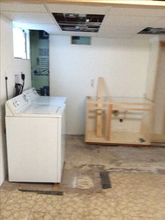 an empty room with a washer and dryer in it