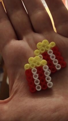 a hand holding three lego pieces in it's palm