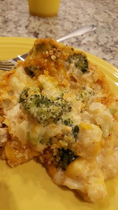 a yellow plate topped with cheesy potatoes and broccoli covered in cheese