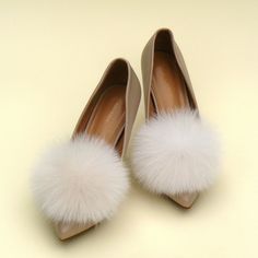 "Add a touch of whimsical charm to your wedding ensemble with these exquisite Fluffy Wedding Pom Pom Shoe Clips! Handcrafted with love, these clips feature lusciously soft and ethically sourced fox fur, ensuring both elegance and sustainability. Each pom pom is meticulously made to perfection, creating a delightful burst of fluffy luxury that will effortlessly enhance your bridal shoes. These versatile clips can be easily attached to any pair of shoes, allowing you to customize your look and embrace your unique style on your special day. Whether you're walking down the aisle or dancing the night away, these pom pom shoe clips are the perfect accessory for every bride seeking a dash of enchantment and a touch of glamour. Embrace the joy of your wedding day with these delightful and eco-cons Cream Shoe, Fluffy Shoes, Shoe Decorations, White Wedding Shoes, Fur Accessories, Cream Shoes, Bride Accessories, Bow Shoes, Womens Wedding Shoes