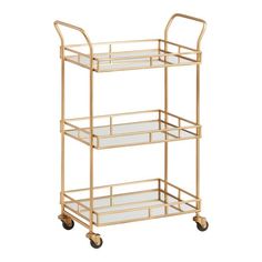 a gold serving cart with three glass shelves on each side and two metal wheels,