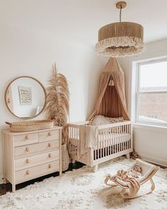 a baby's room with a crib, dresser and mirror in it is shown